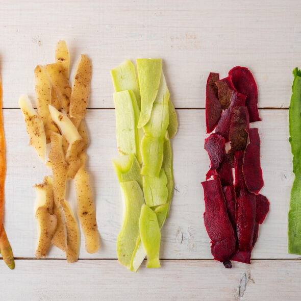 vegetable peels on white wooden background, compost concept, recycling of food waste, top view, flat lay